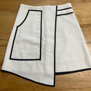Asymmetrical mini skirt. Chicwish. White with black trim. Size Small.